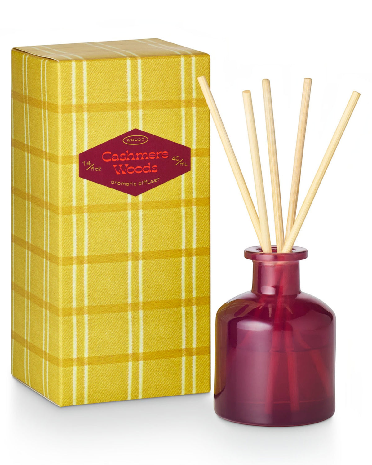 Mustard yellow plaid box with "Cashmere Woods" printed shown next to a berry glass diffuser vessel with reeds.