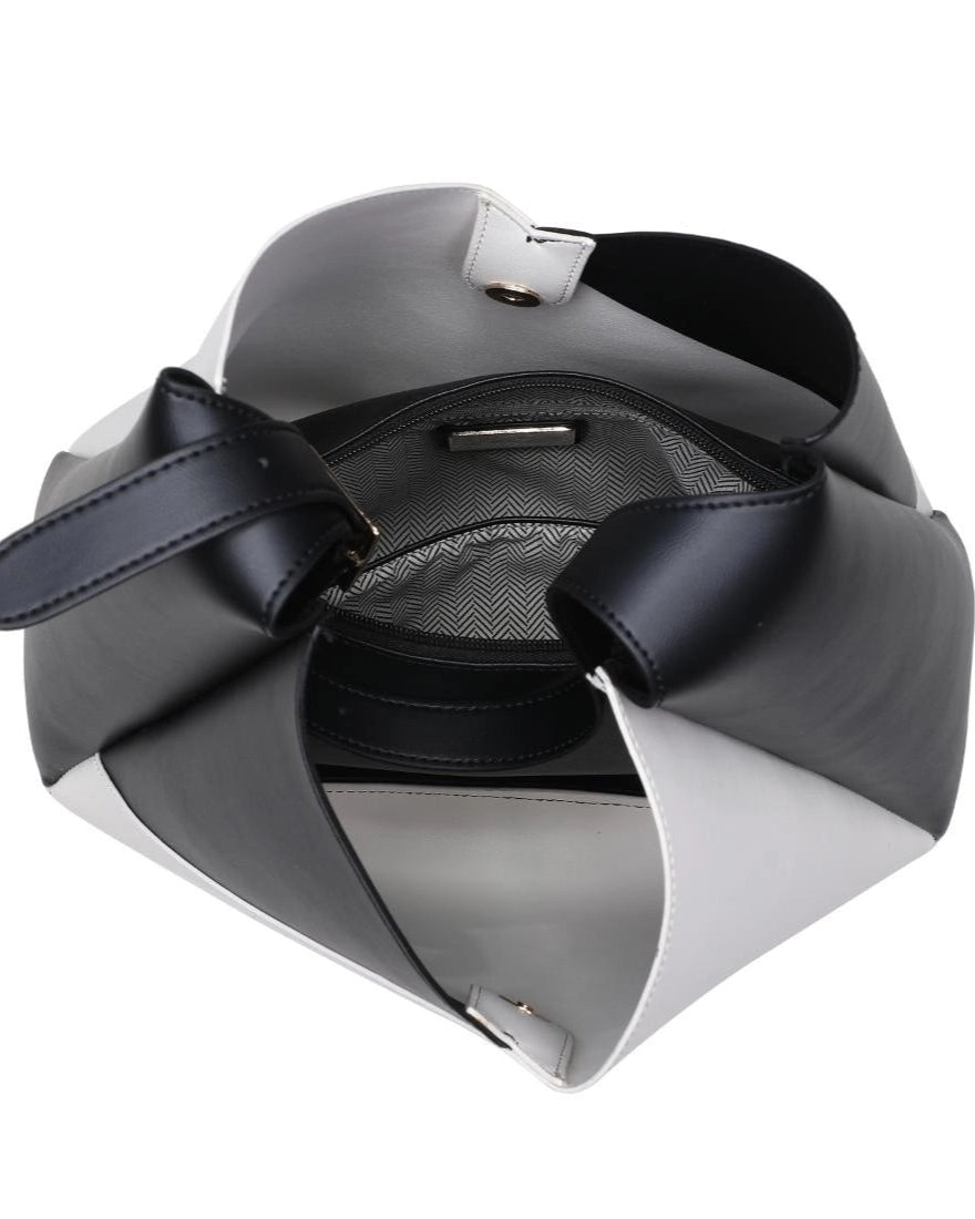 Interior view of black and white handbag on a white background.