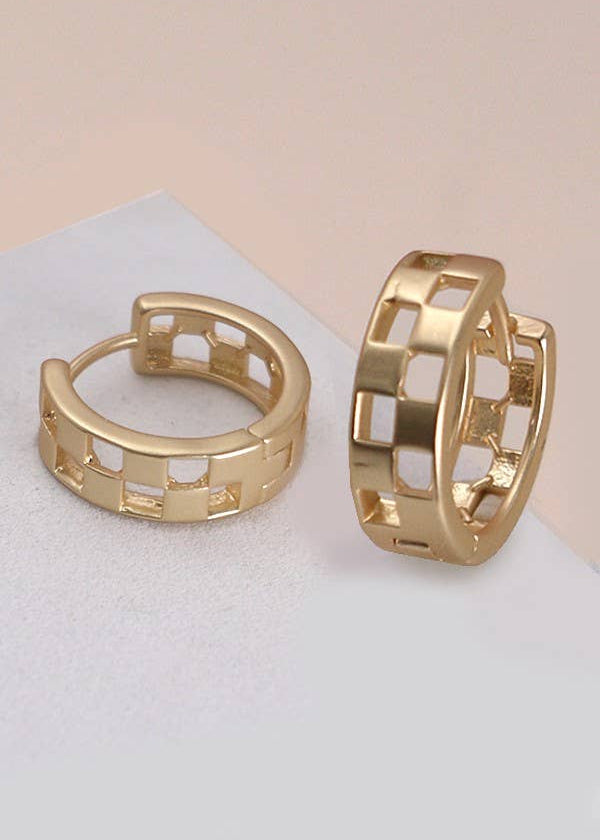 Mini checker cutout huggie hoop earrings in matte gold or silver, featuring a modern geometric design and a snug, comfortable fit.