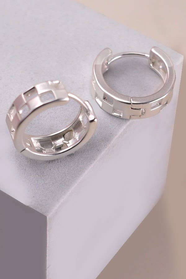 Mini checker cutout huggie hoop earrings in matte gold or silver, featuring a modern geometric design and a snug, comfortable fit.