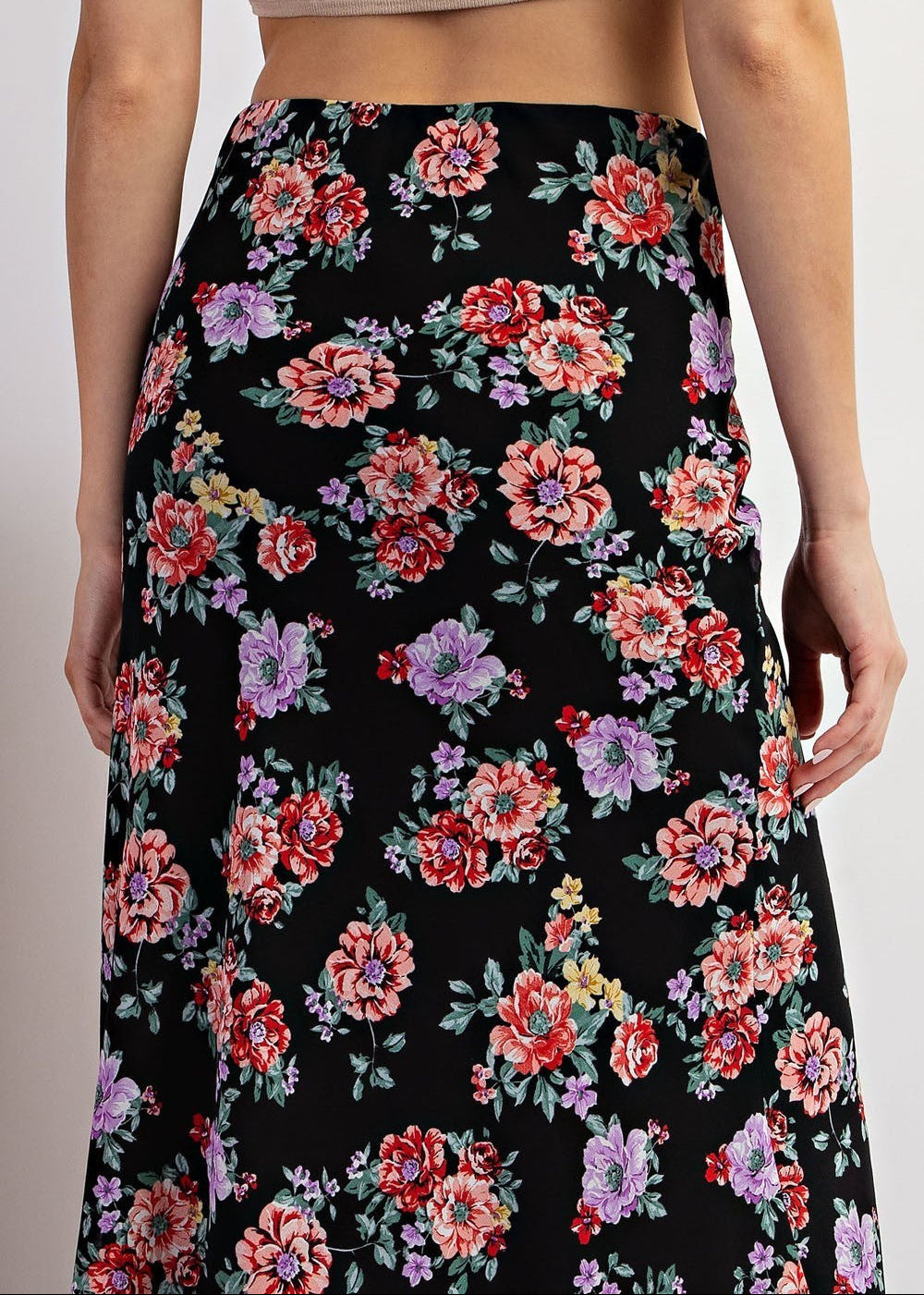 Black floral maxi skirt with red and purple blooms and A-line silhouette.