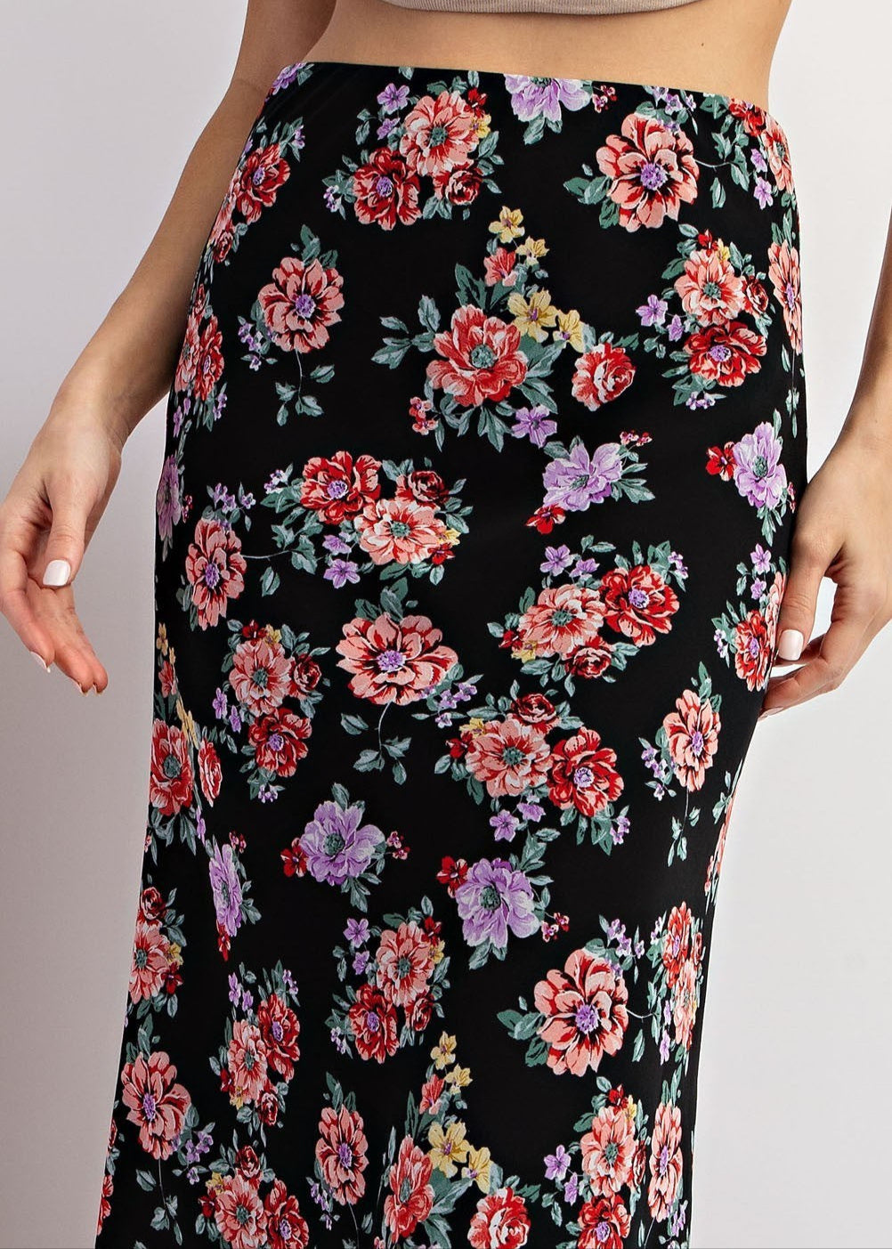 Black floral maxi skirt with red and purple blooms and A-line silhouette.