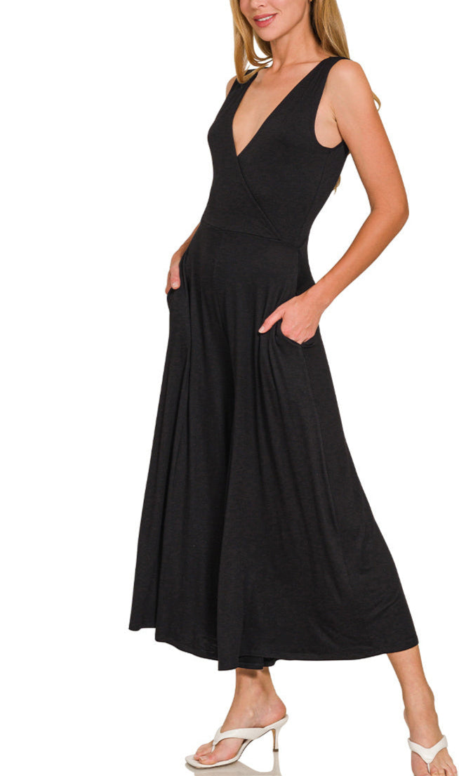 Woman wearing a black sleeveless wide-leg jumpsuit with a deep V neckline.