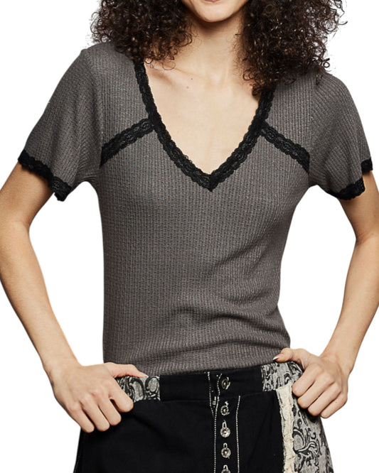 Woman wearing a gray short-sleeve top with lace trim on a white background.