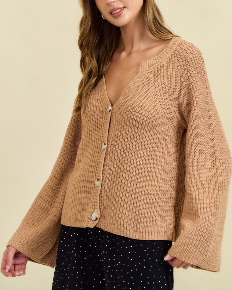Tan ribbed button cardigan with blouson sleeves and gold buttons.