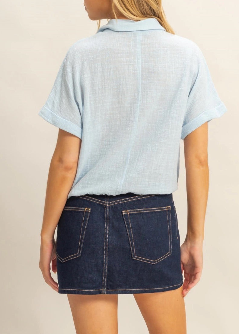 Sky Blue short sleeve 100% cotton button-up shirt with drawstring hem.