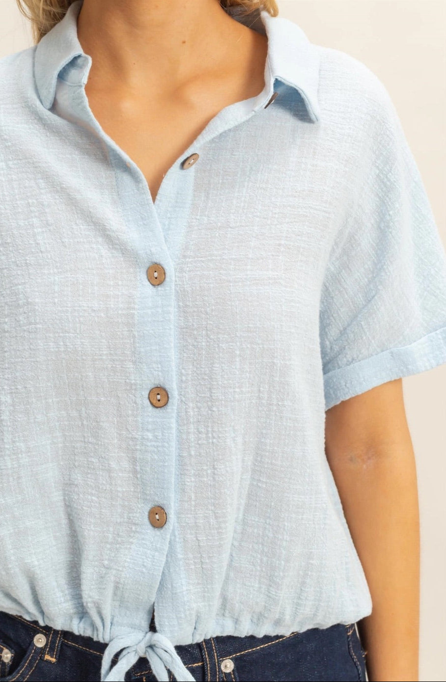 Sky Blue short sleeve 100% cotton button-up shirt with drawstring hem.