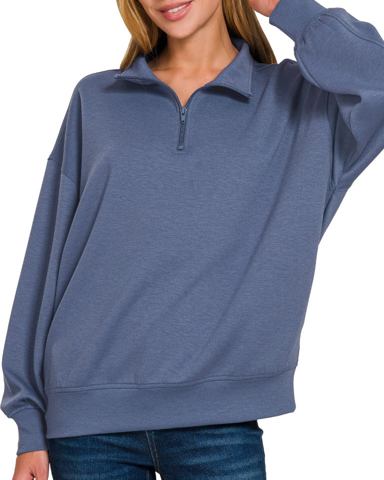 Woman wearing a Blue Indigo half-zip scuba pullover with relaxed fit and soft stretch fabric.