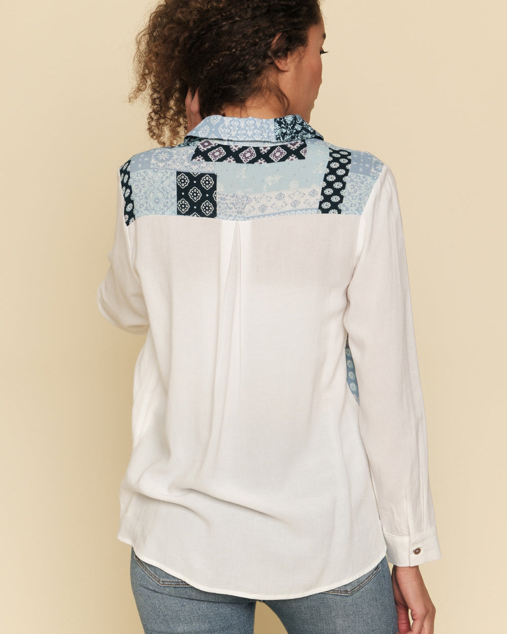 White and blue mixed print button-down shirt with bust pocket.