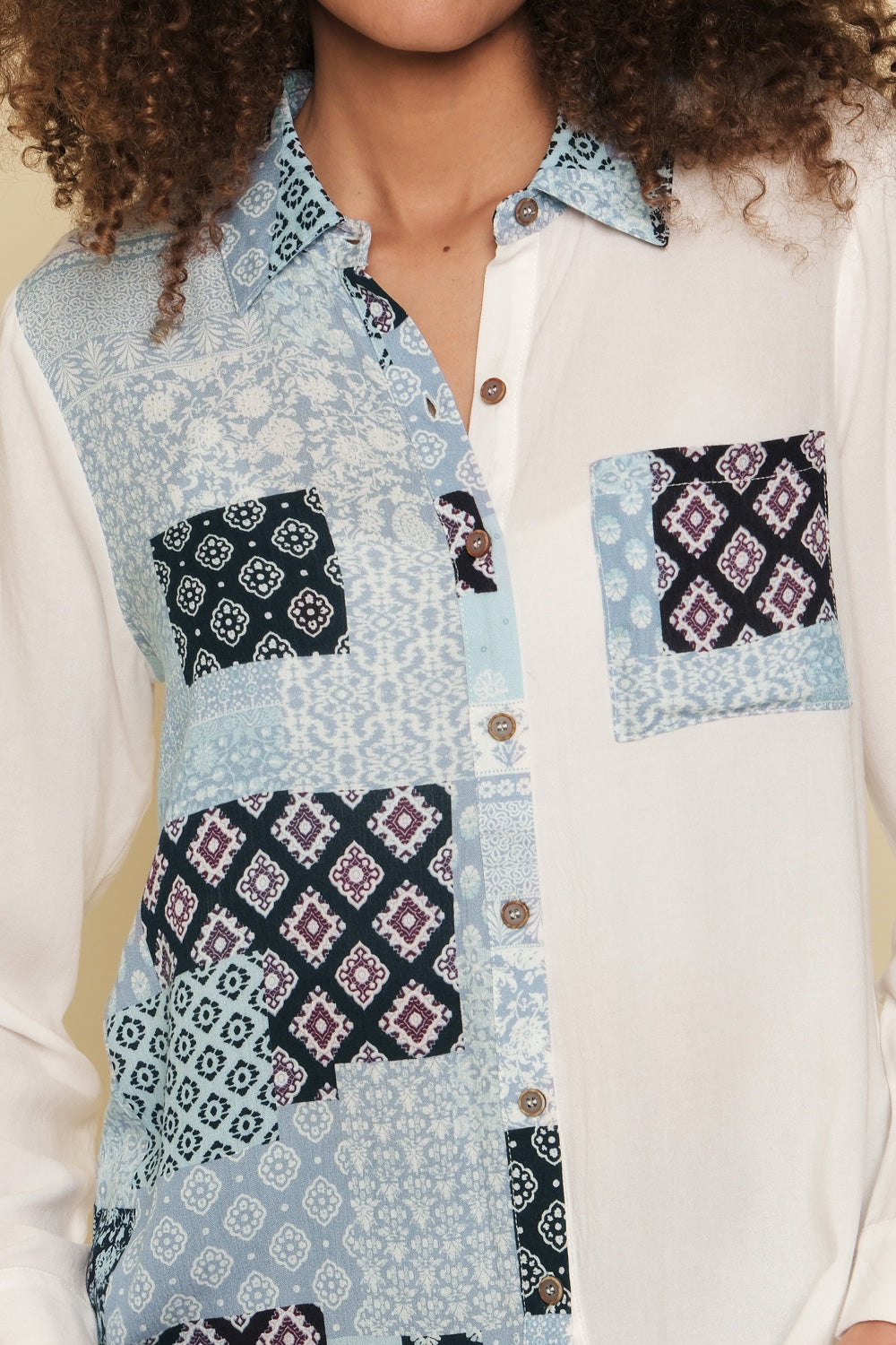 White and blue mixed print button-down shirt with bust pocket.