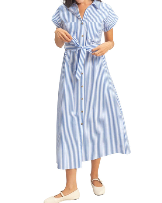 Woman wearing a blue and white striped dress on a white background