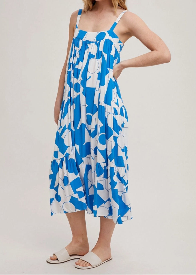Blue and white geometric print tiered maxi dress with adjustable straps.