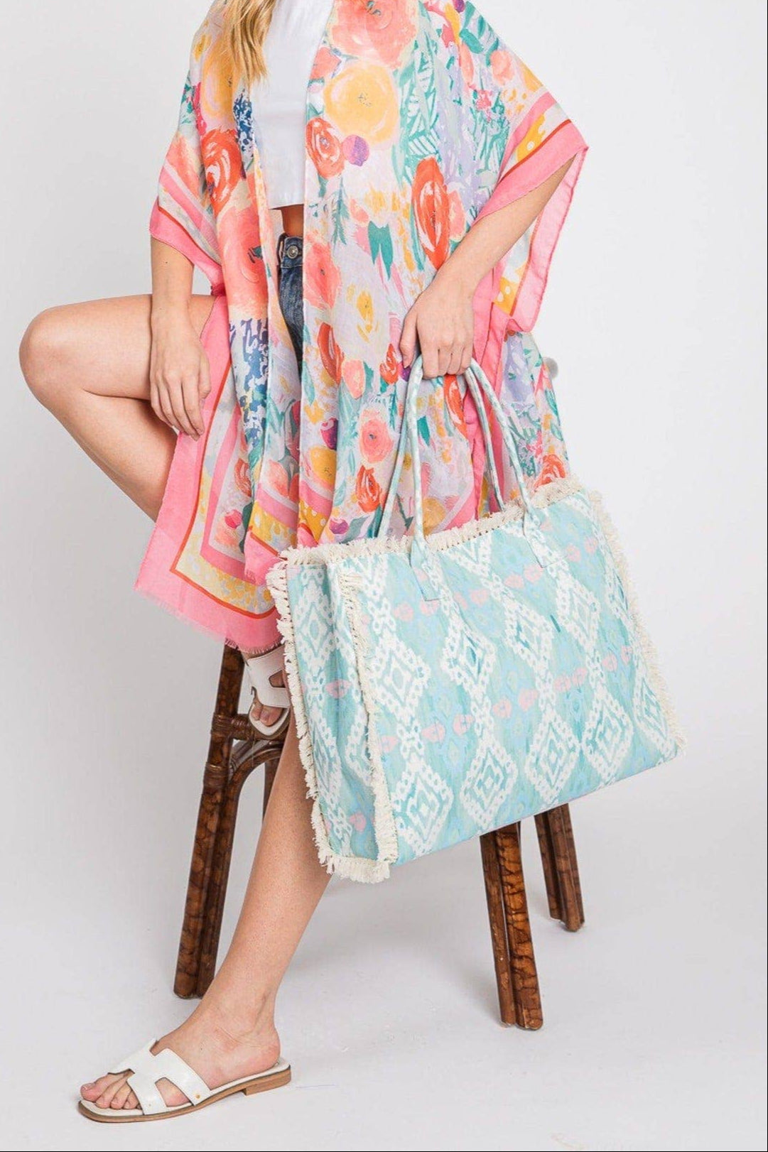 Aqua blue fringe boho beach bag with snap closure and soft texture.