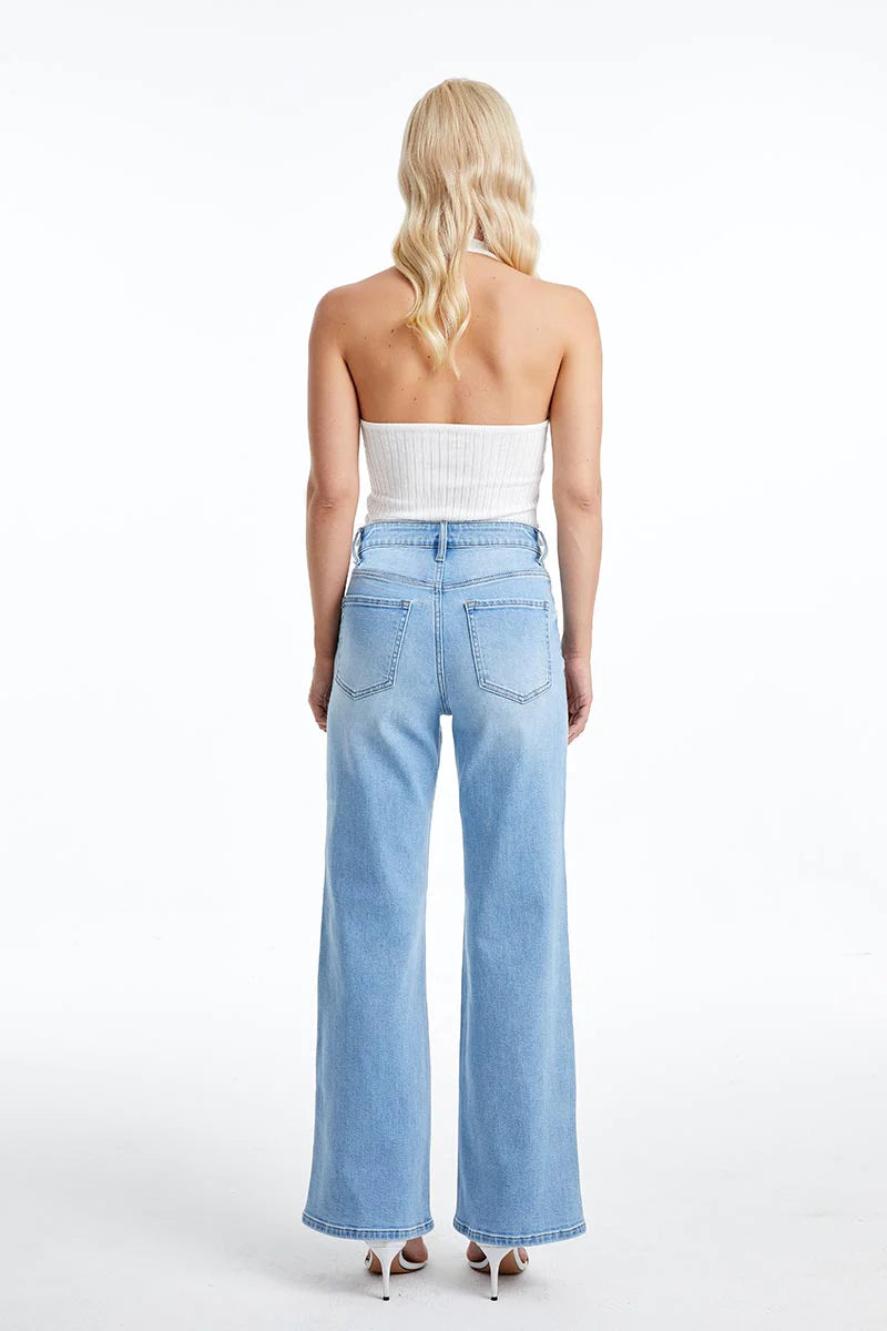 Back view of a woman wearing Wide Straight Leg Comfort Stretch Jeans in Swiss Blue.