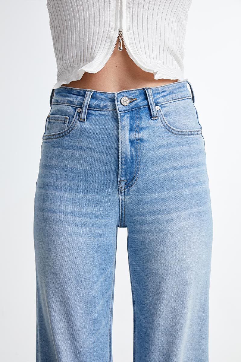 Close up of a woman wearing Wide Straight Leg Comfort Stretch Jeans in Swiss Blue.