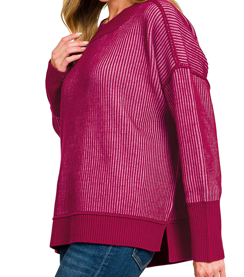 Woman wearing a cabernet candy pink sweater on a white background.