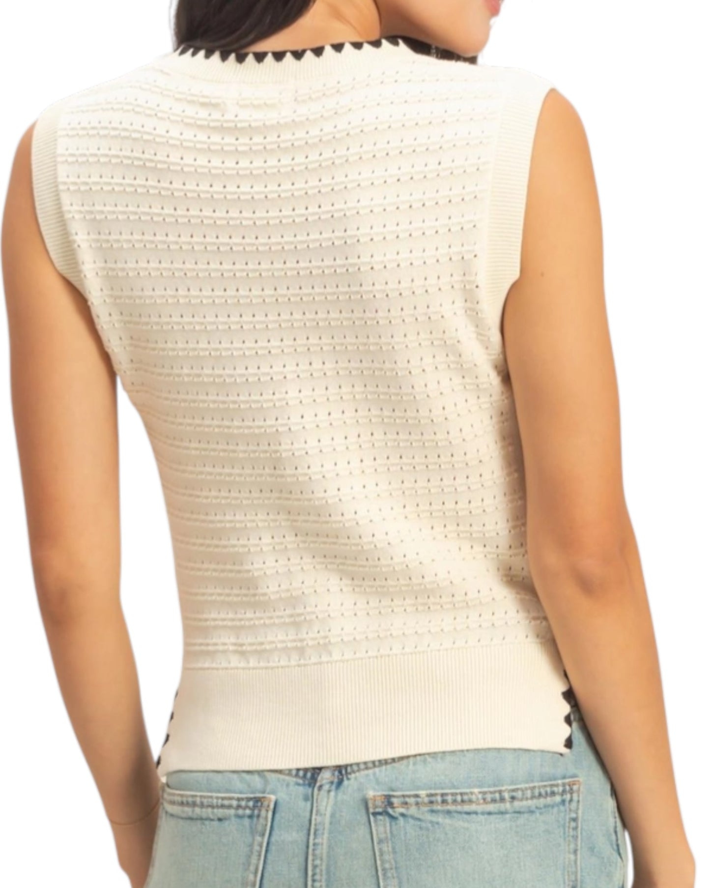Cream sleeveless top worn by a person on a white background.