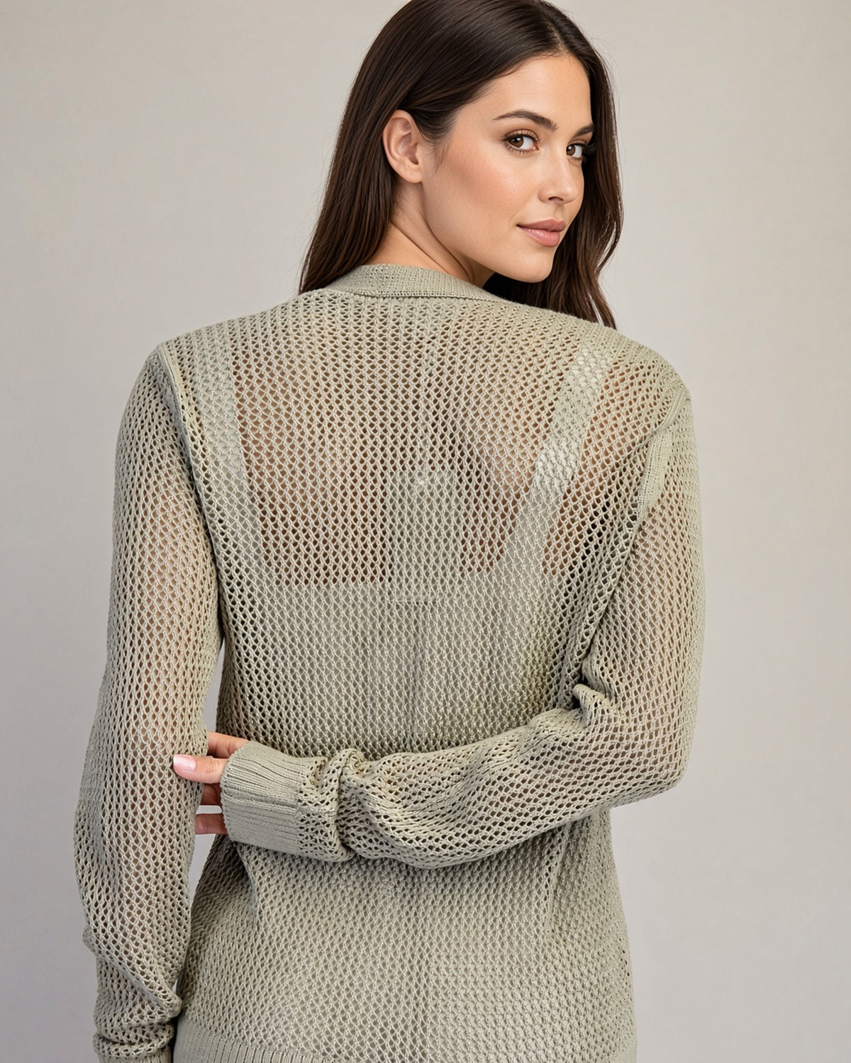Back view of Dry Herb cardigan showing airy mesh knit, long sleeves, and wide ribbed hem.