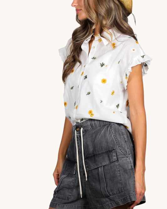Off-white embroidered cotton top with ruffle cap sleeves and button-front closure