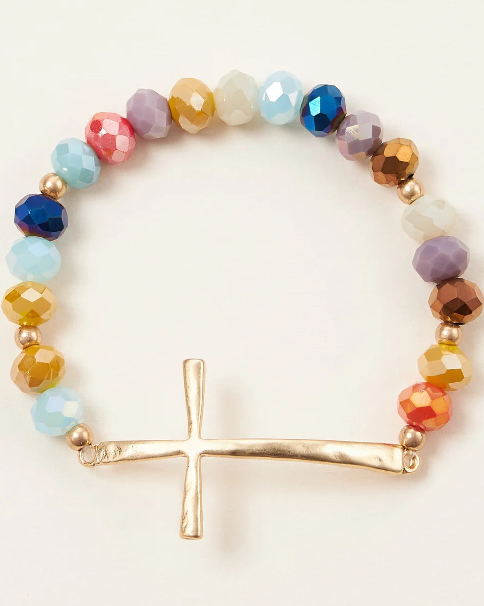 Multi-color glass bead stretch bracelet featuring a hammered gold cross charm, symbolic and stylish for everyday wear.