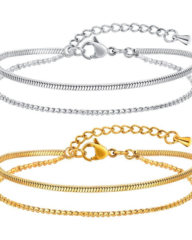 Two gold and silver snake chain bracelets on a white background