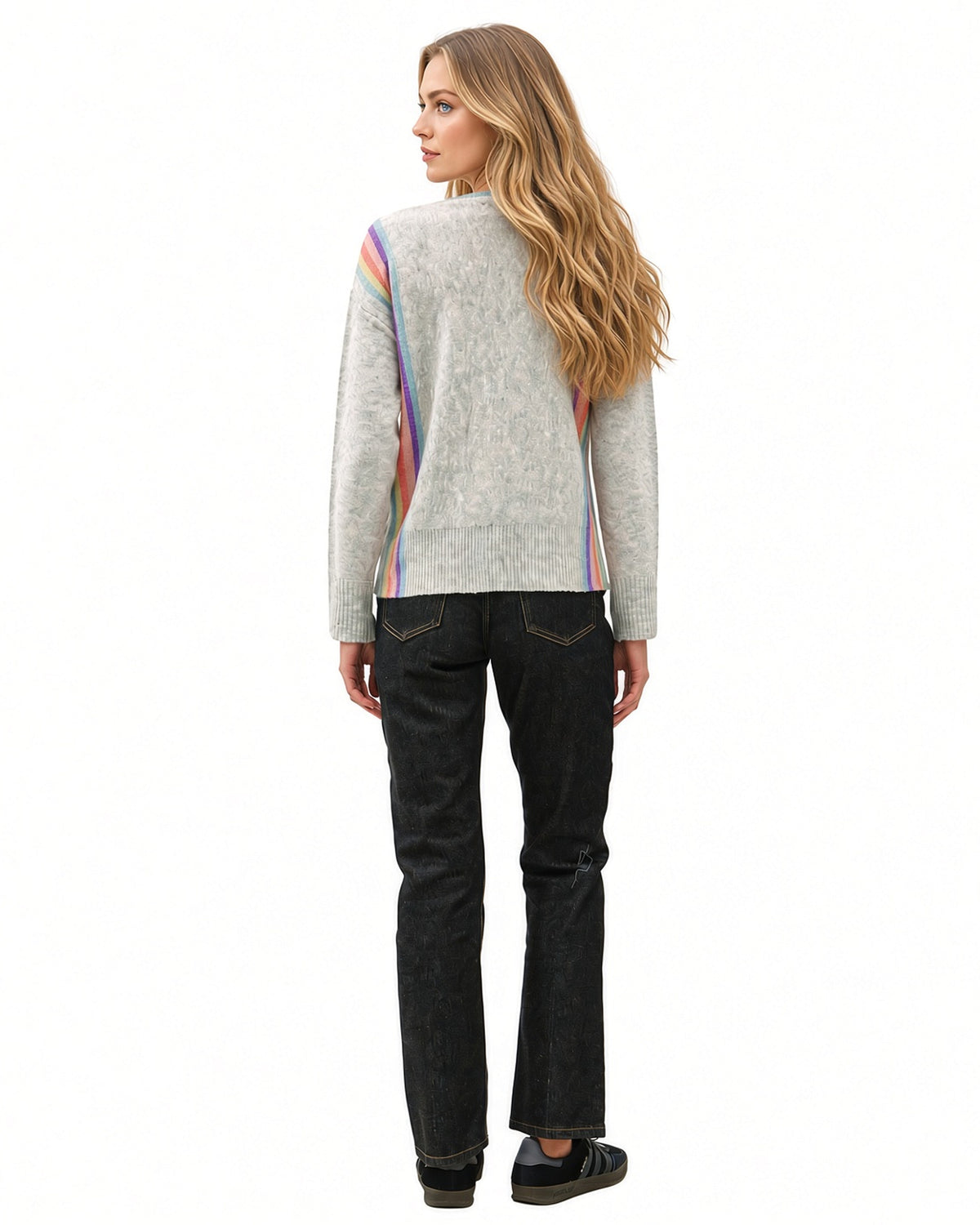 Back view of model wearing grey Rainbow Prism crewneck sweater with rainbow side stripes and ribbed cuffs and hem.