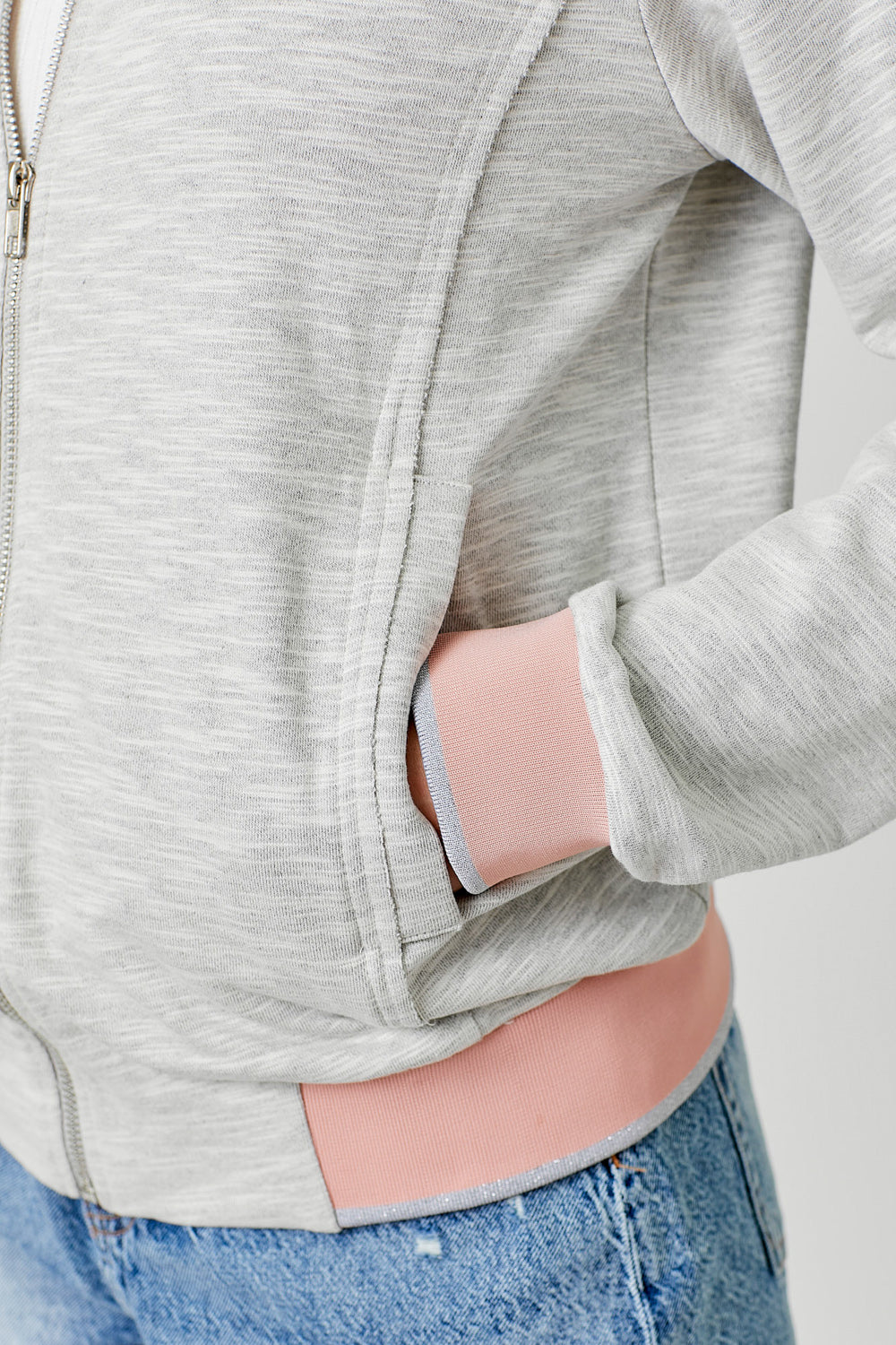 Heather grey bomber jacket with pink and silver contrast details on hem, sleeves and neckline.