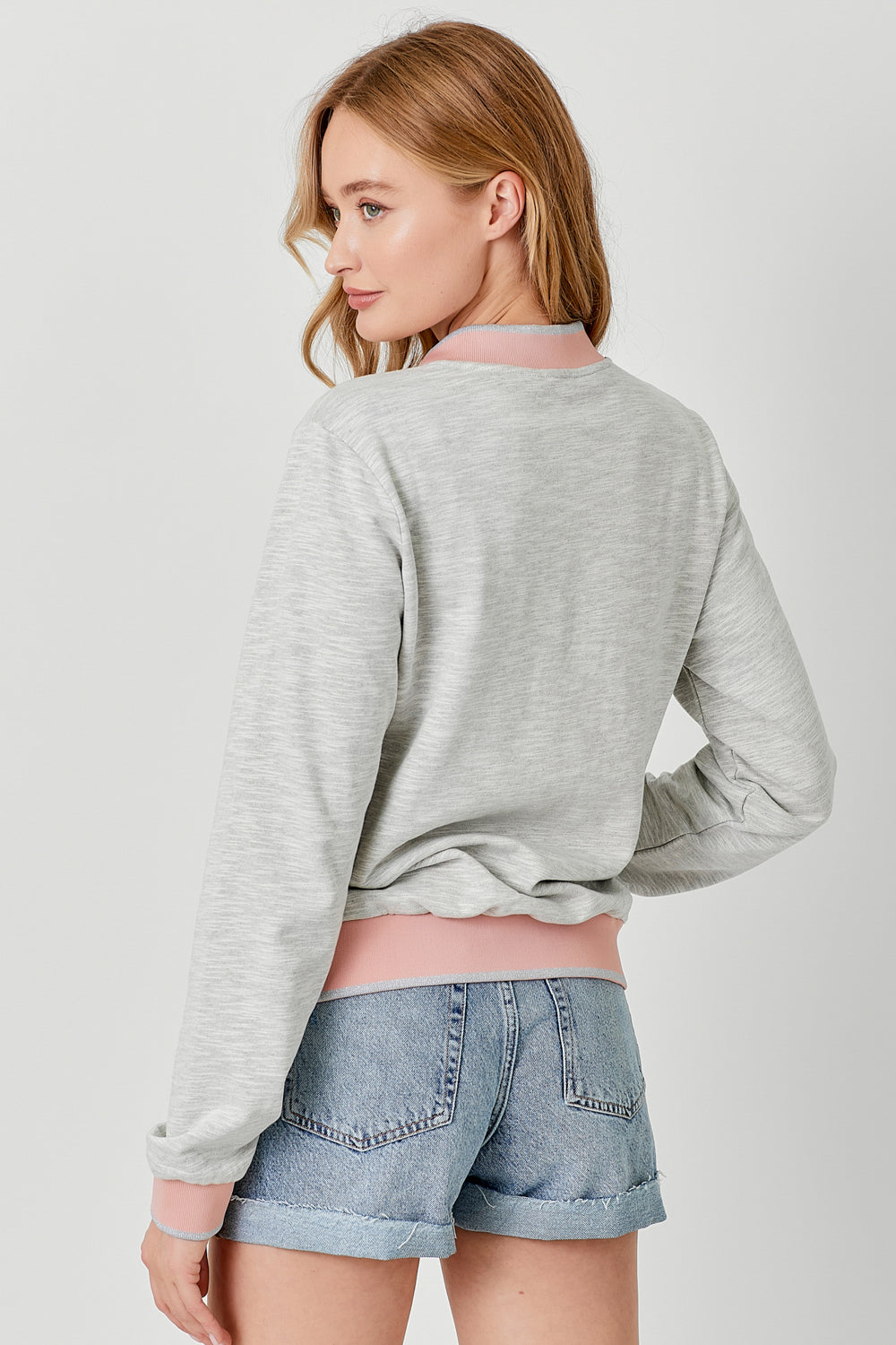 Heather grey bomber jacket with pink and silver contrast details on hem, sleeves and neckline.