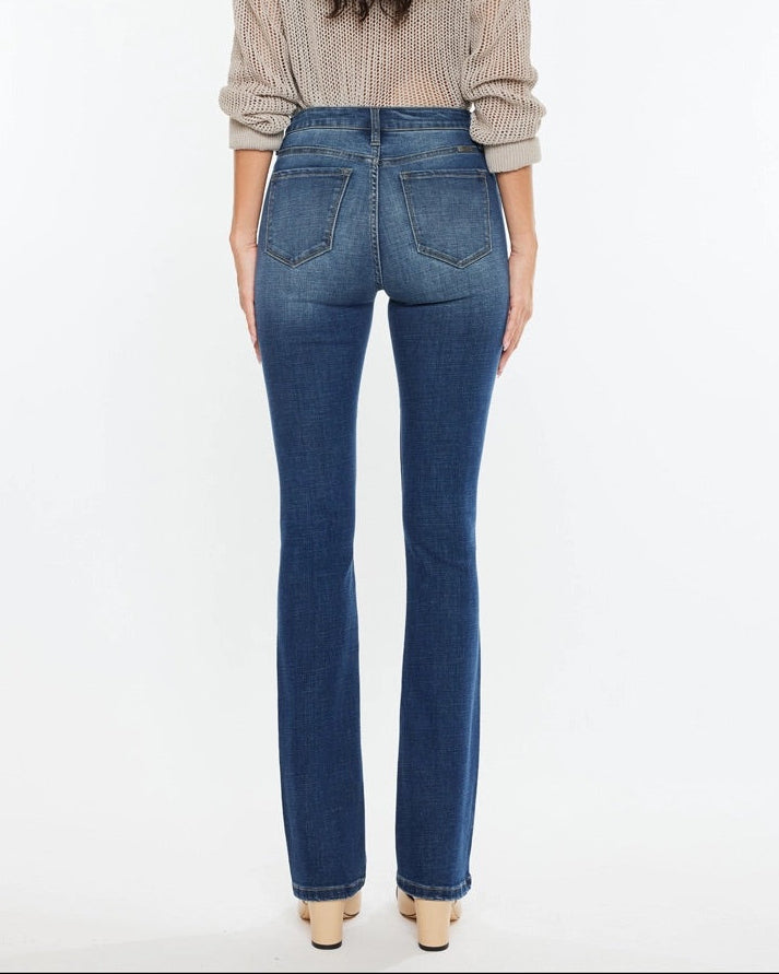 Woman wearing Kan Can High Rise Skinny Bootcut Jeans in medium wash denim.