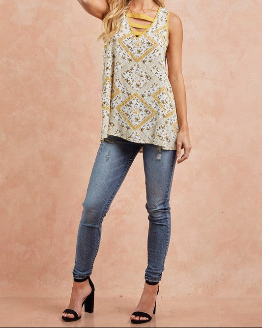 Floral print sleeveless tank top with strappy V-neckline in honey gold and cream.
