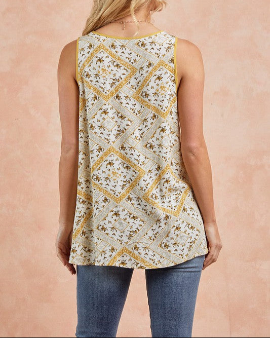 Floral print sleeveless tank top with strappy V-neckline in honey gold and cream.
