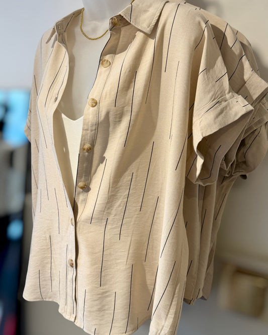 Light khaki shirt with brown stripes on a mannequin against a neutral background.