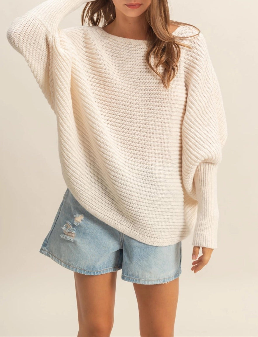 Ivory oversized dolman sweater with wide-knit texture and relaxed fit.