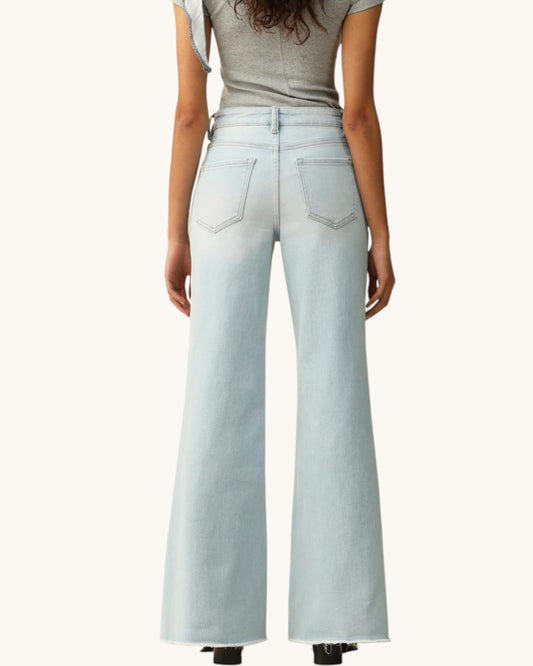 Light blue jeans worn by a person on a white background