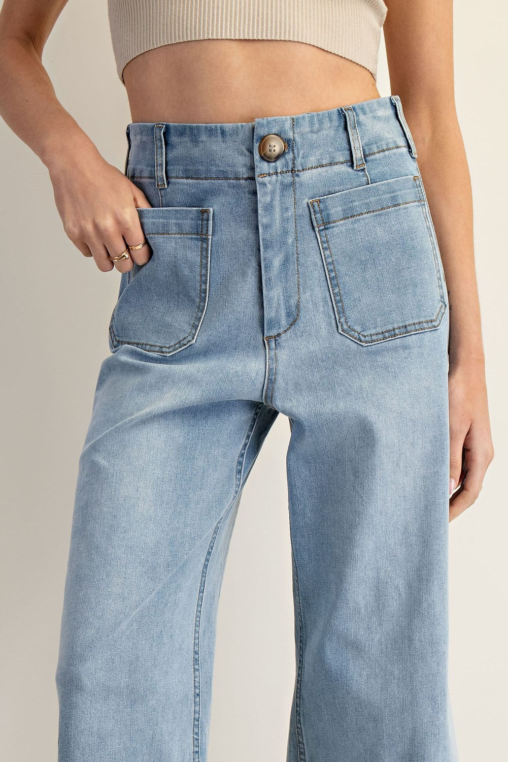 Light wash wide-leg cropped denim pants with front patch pockets and contrast seaming.