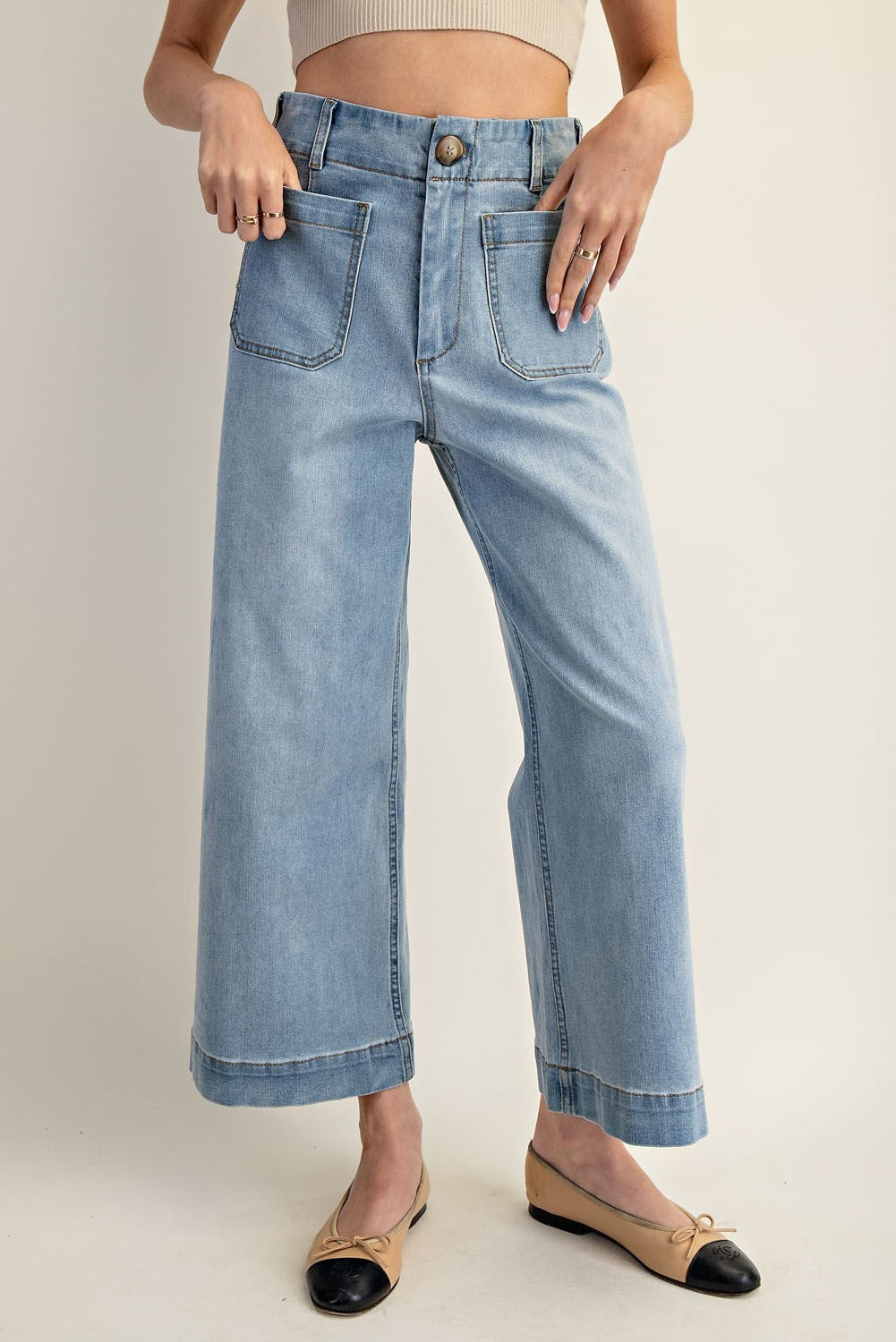 Light wash wide-leg cropped denim jeans with front patch pockets and contrast seaming.