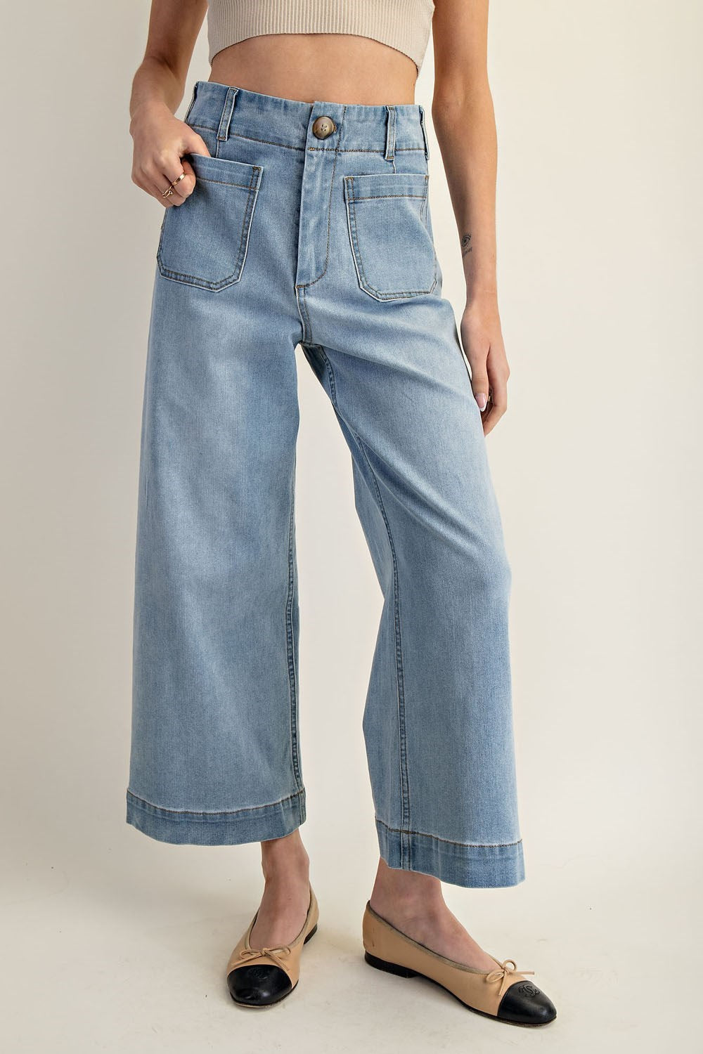 Light wash wide-leg cropped denim jeans with front patch pockets and contrast seaming.