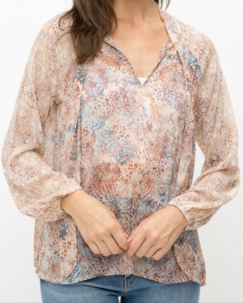 Mixed animal print patterned semi-sheer long sleeve blouse with a V-neckline and tie front.