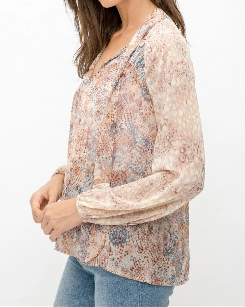 Mixed animal print patterned semi-sheer long sleeve blouse with a V-neckline and tie front.