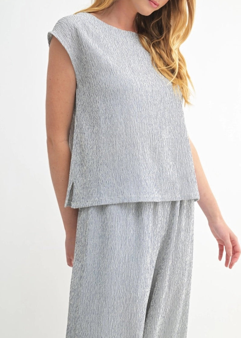 White and Navy sleeveless top with heathered texture and modern cut.
