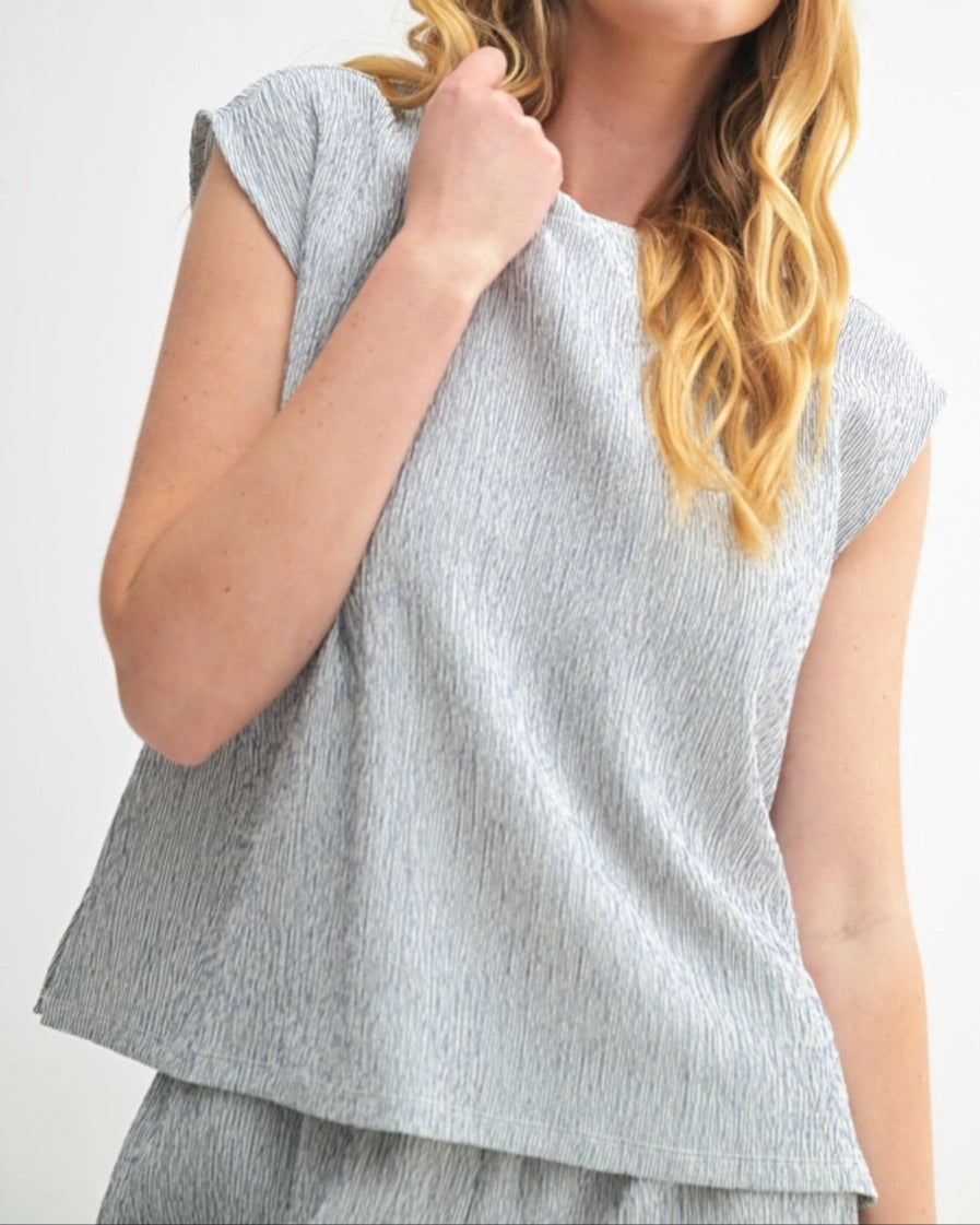 Navy sleeveless top with heathered texture and modern cut.