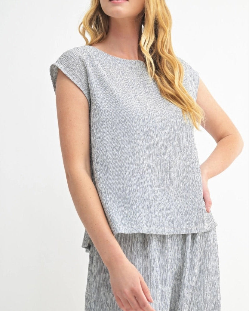 Navy sleeveless top with heathered texture and modern cut.