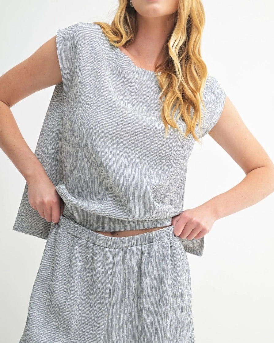 Navy sleeveless top with heathered texture and modern cut.