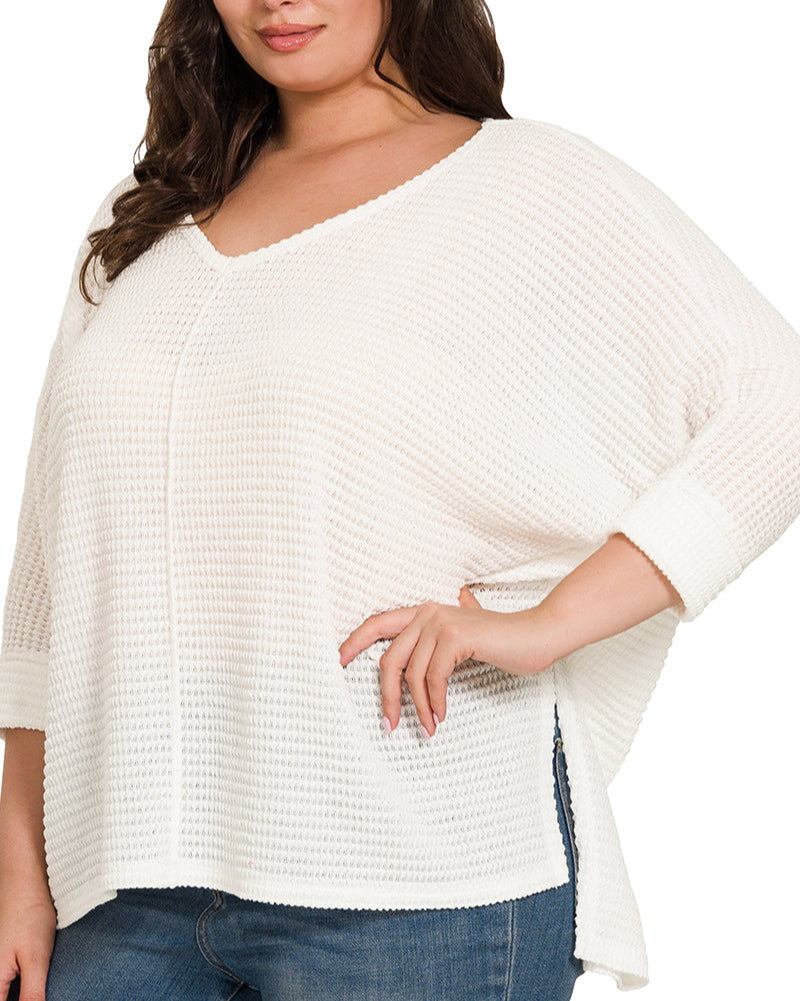 Curvy white lightweight jacquard V-neck top with flowy fit and three quarter sleeves.