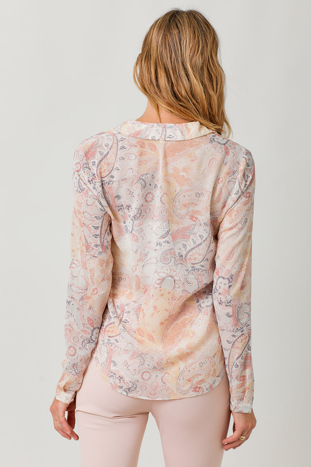 Semi-sheer pastel paisley tie-front blouse with V-neck and hi-lo hem.