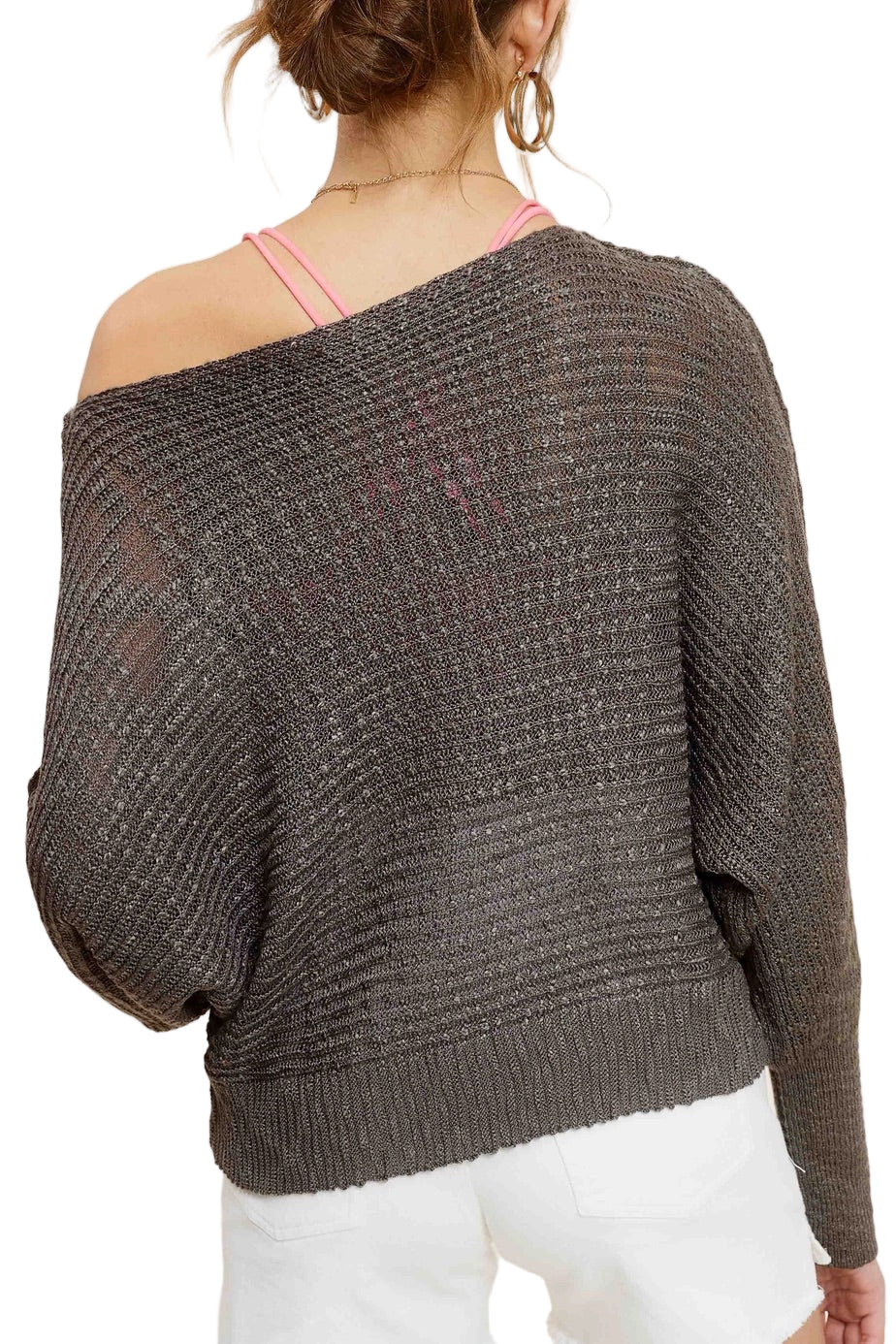 Woman wearing Pebble/Grey lightweight dolman sleeve boat neck sweater with exposed seams.
