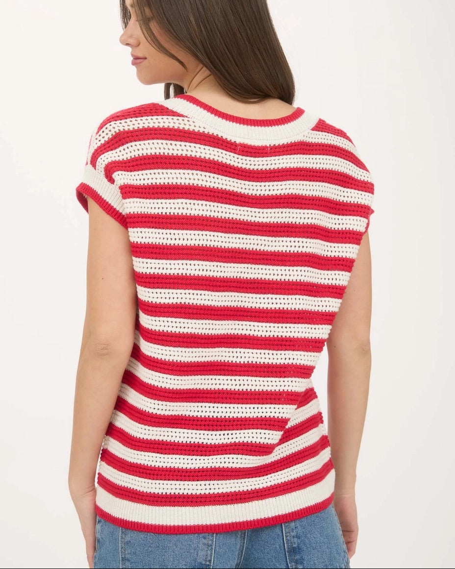 Back view of a woman wearing a red and white striped short sleeve cotton sweater on a white background.