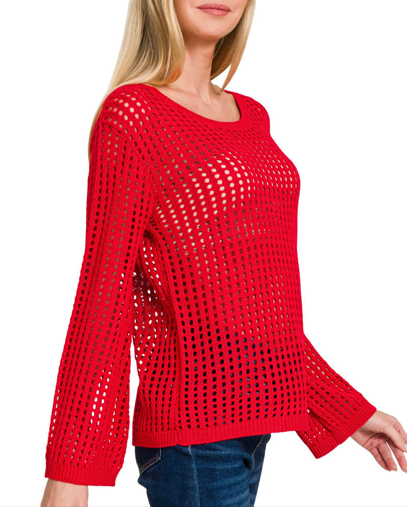 Woman wearing bold red open knit long sleeve top with flare sleeves and scoop neckline.