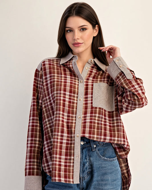 Front view of rust plaid shirt showing striped chest pocket and contrasting long sleeve cuffs.