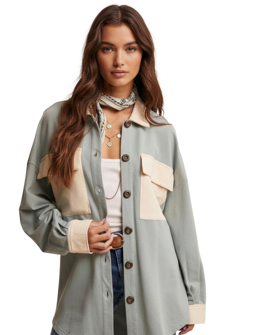 Woman wearing a light sage jacket with ivory accents on a white background.